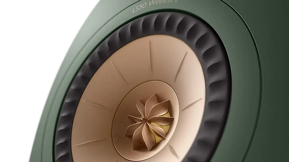 Close-up of a green LS50 Wireless II speaker with a gold and black concentric design, showcasing intricate patterns and detailing.