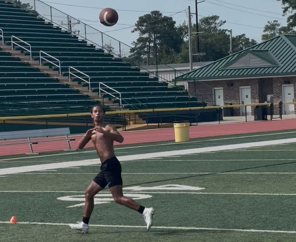 Eye-level view of a football player practicing footwork drills on a grassy field