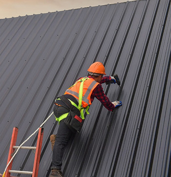 Man drilling into a coloursteel roof
