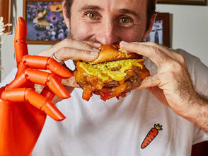Man taking big bite out of juicy beef burger