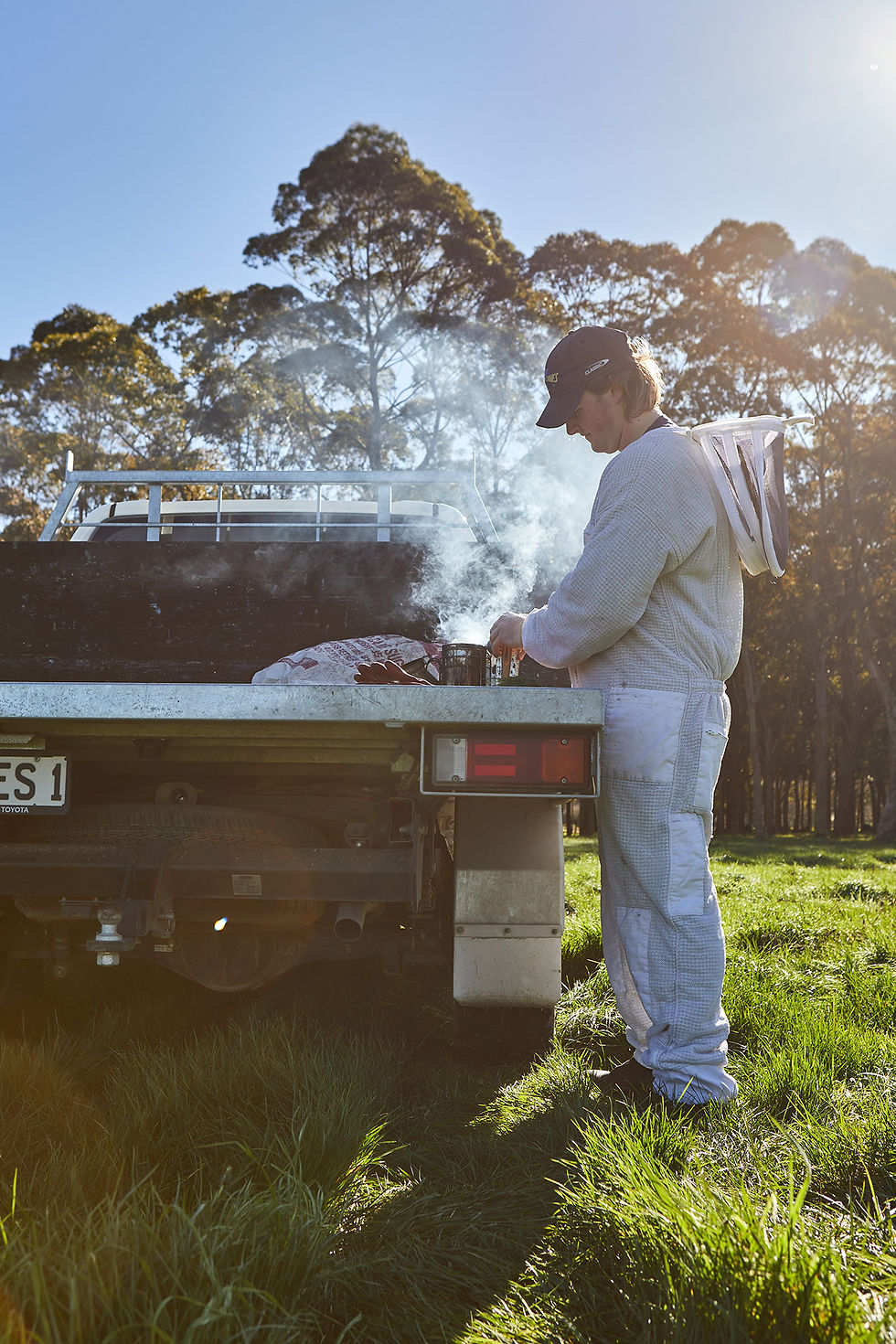 Joseph preps the bee smoker before checking on hives