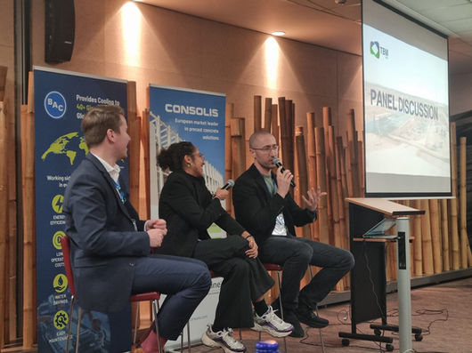 Zach speaking at a battery industry event as a member of an expert panel in front of a crowd, showcasing his expertise on manufacturing training and documentation