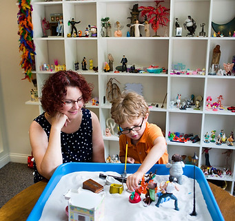 Play therapy session with a therapy sand table for child therapy in Madison, WI at Golden Vibes Counseling for children in Wisconsin.
