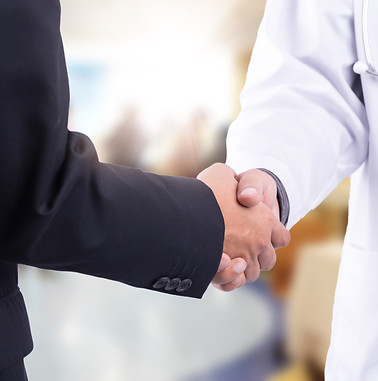 Doctor and businessman shaking hands