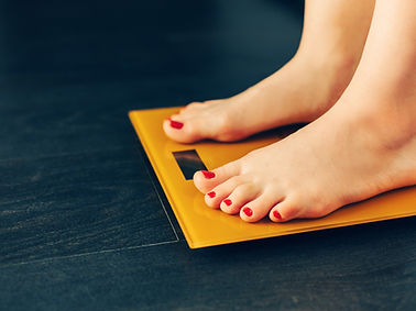 Girl standing on electric scales