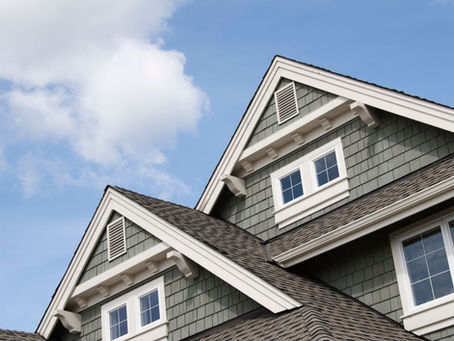 view of a house's siding and windows with the sky in the background