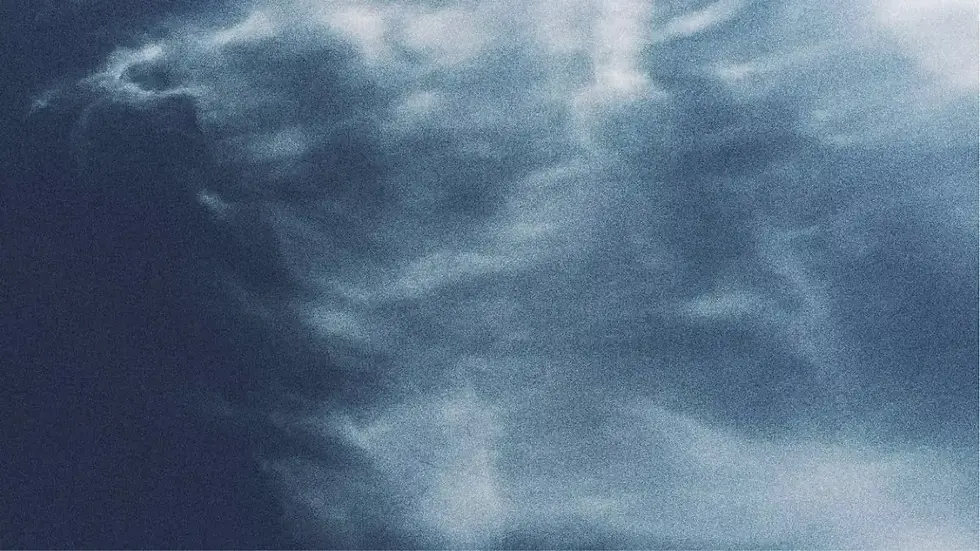 White adjustable treatment chair in a clean, modern spa aesthetic room.