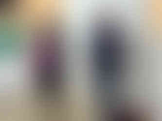 Smiling woman receiving a bouquet of flowers as a gift, stood next to a man