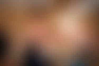 Woman with arms outstretched in a yoga pose, eyes closed in relation and focus.