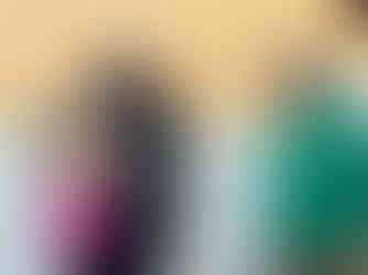 Smiling woman receiving a bouquet of flowers as a gift, stood next to a man