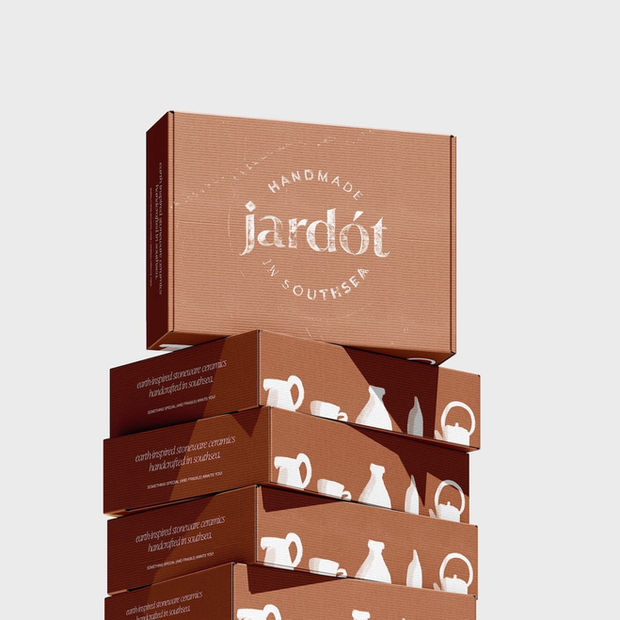 Stacked brown packaging boxes with 'jardót HANDMADE' logo