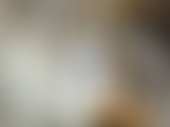 A white ceramic angel bell hanging from a tree