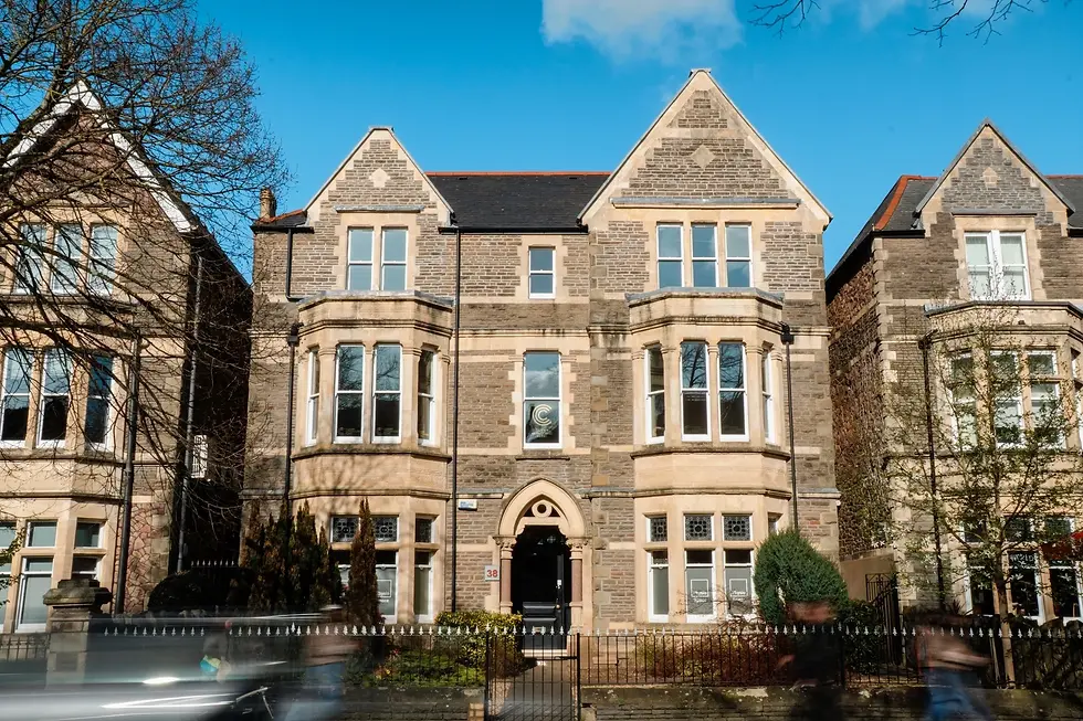 Outside Cardiff Ultrasound Clinic on 38 Cathedral Road on a sunny day, with cars and people moving past the building