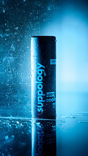 Suppology bottle with water droplets on a blue background