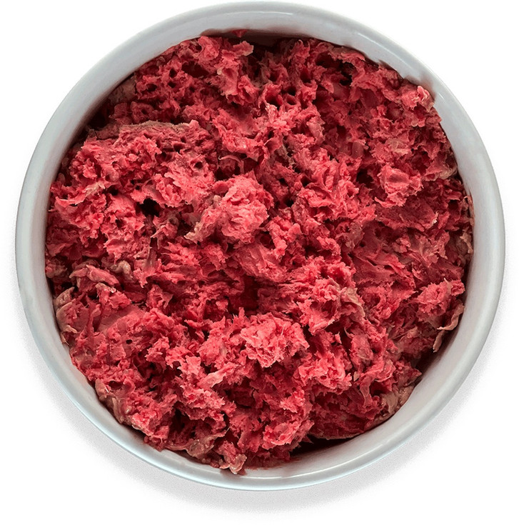 Close-up of raw pet food in a white bowl, ready for serving.