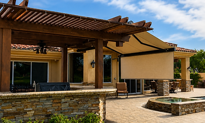 adding a retractable awning to a bbq outside eating area helps keep the sun away for more enjoyment longer