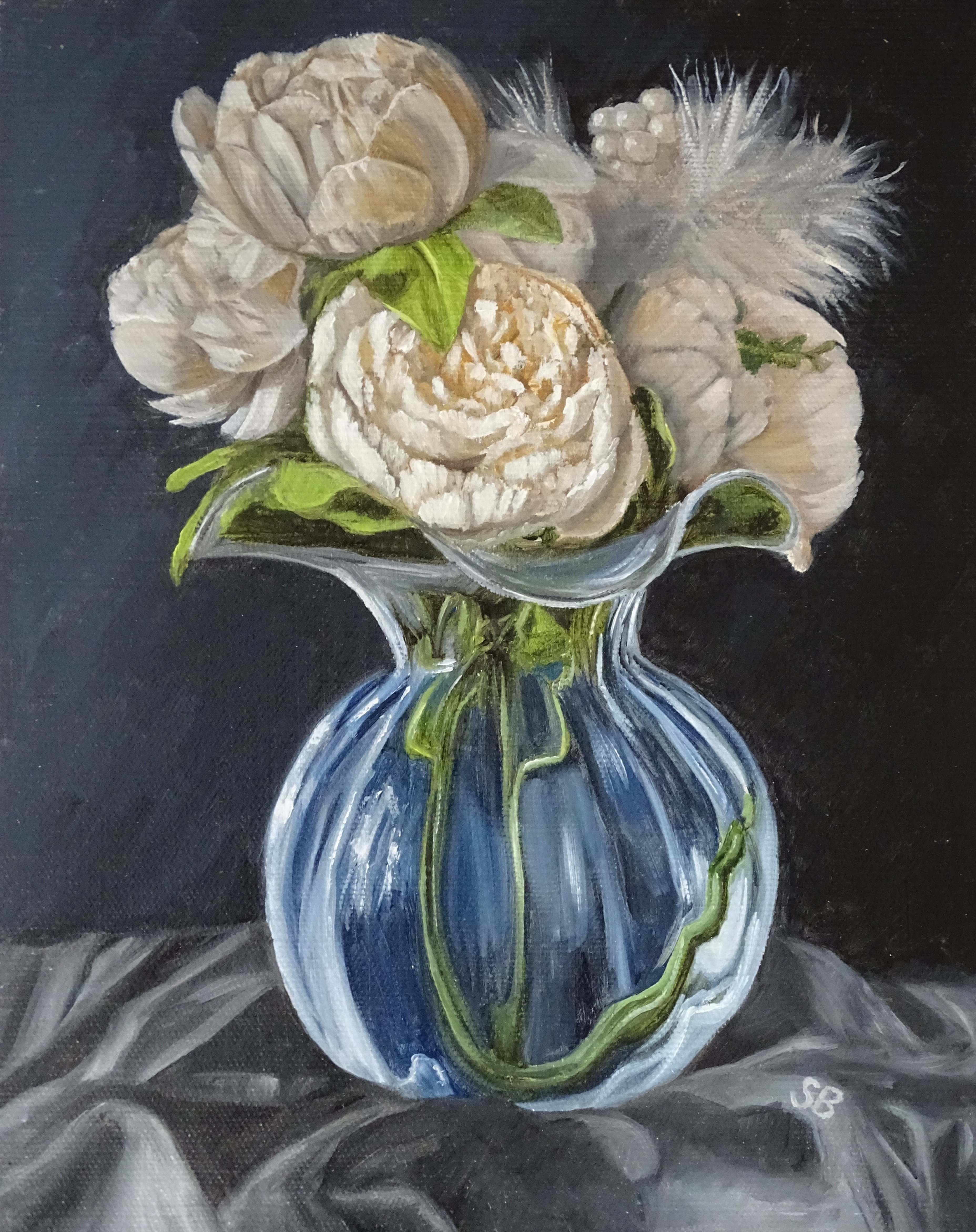 Peonies in a glass vase on a dark background