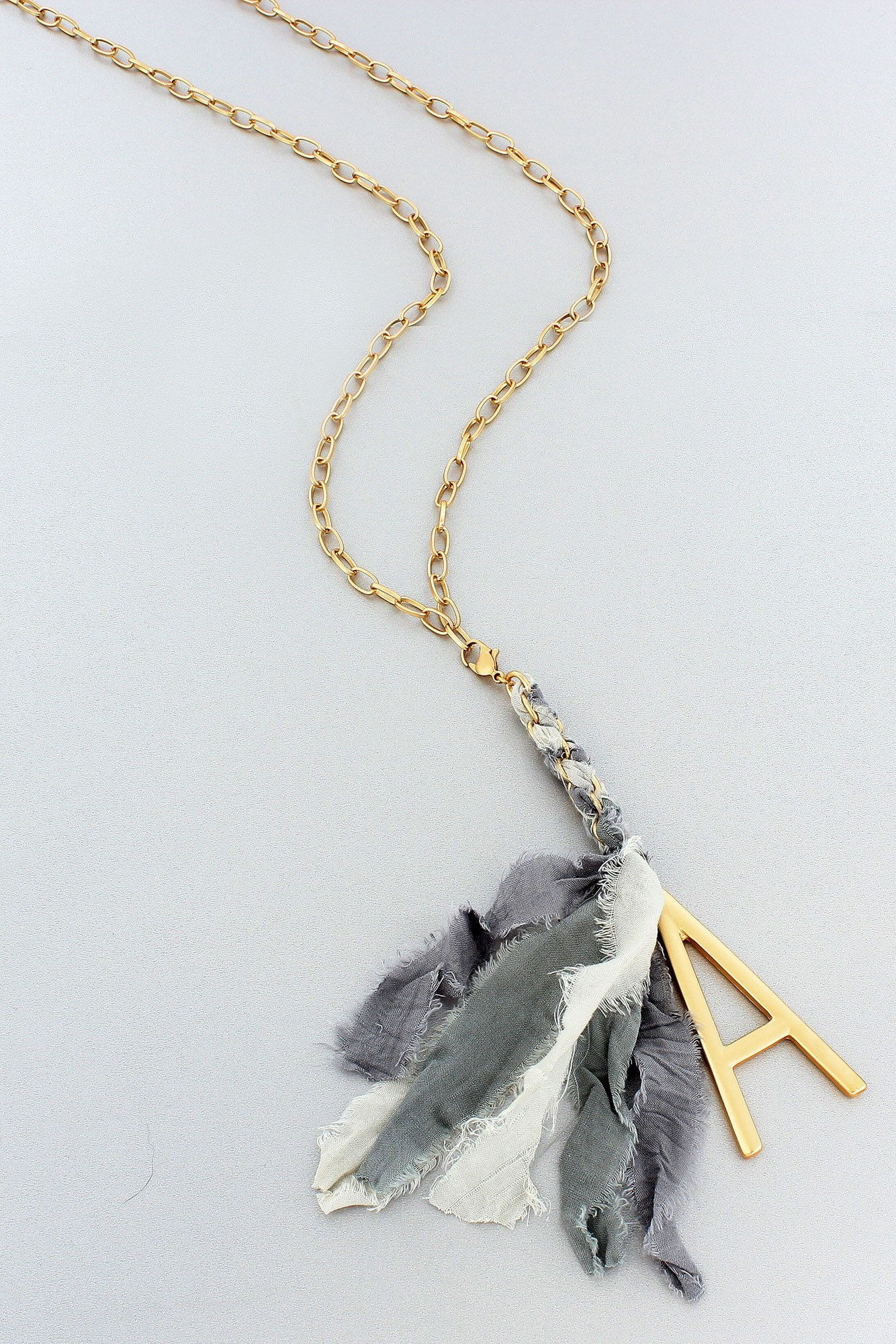 Matte Goldtone Initial and Gray Fabric Tassel Necklace