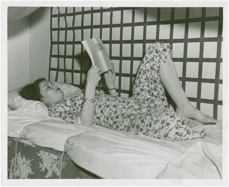 Woman reading in a bunk, World's Fair 1935