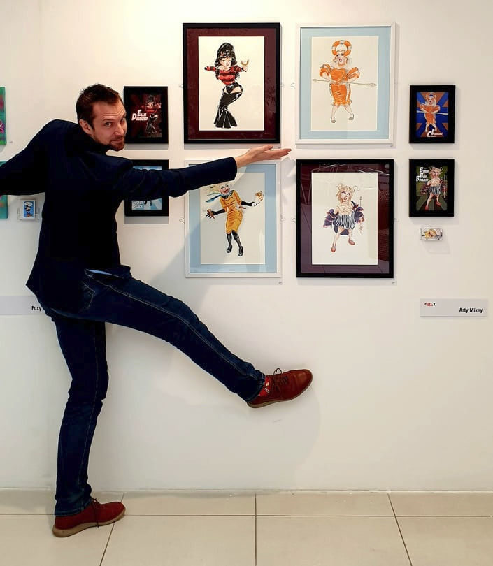 ArtyMikey next to his artwork in the Digbeth Art Space exhibition.