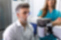 Man performing pulmonary function test and spirometry using spirometer at medical clinic.