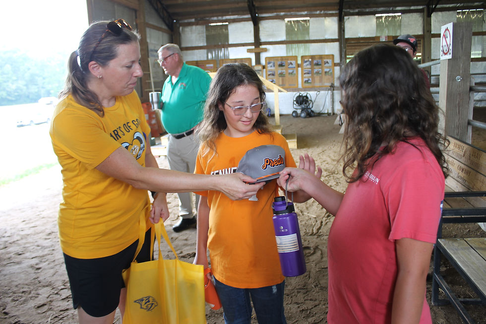 Rebecca King, representative of the Nashville Predators, surprises the riders with their own swag bag of Preds merchandise.