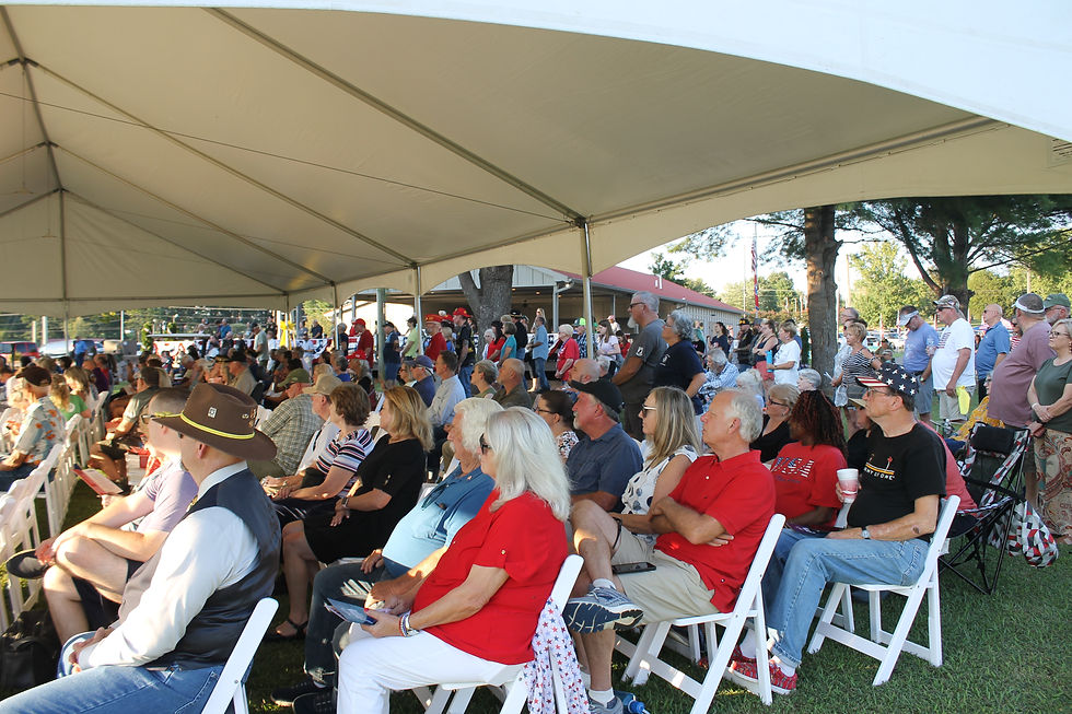 Community members from Franklin County and beyond gather under a tent at the Red Roof Pavilion as the Memorial Wall Ceremony took place last Thursday evening.