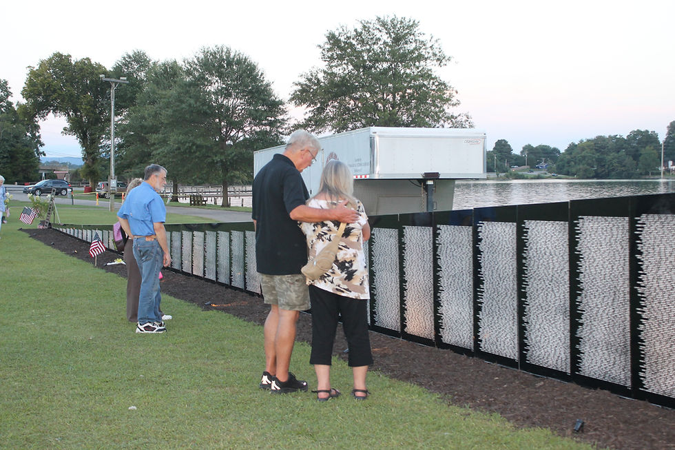 Families gather at the location of the name of their loved one to place flowers and share a moment of silence, remembrance, and reflection.