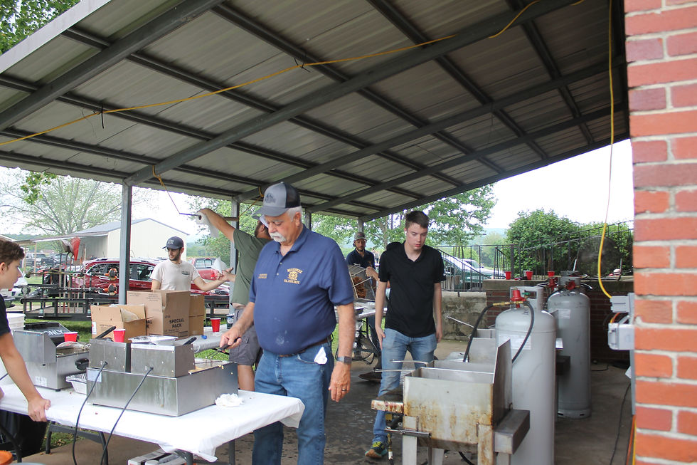 Volunteers prepare food behind the Belvidere Community Center, as they get ready for the crowd to arrive at the Belvidere Volunteer Fire Department Fish Fry