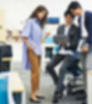 Two coworkers organizing clothing and coordinating tasks inside a fashion workspace
