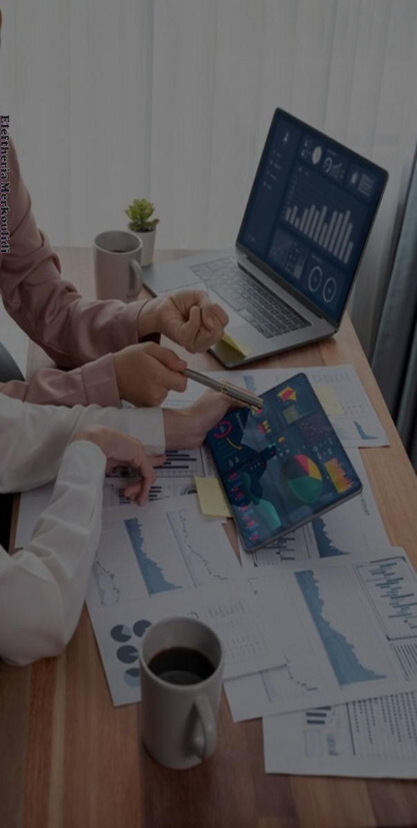 Team analyzing business charts and metrics on a tablet during a meeting