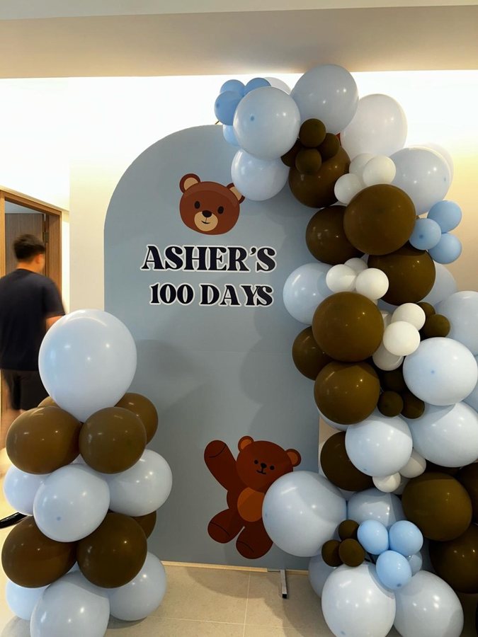 Custom printed teddy-bear foam board backdrop with a brown, blue and white Chiara garland