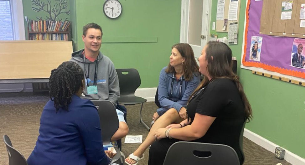Private school staff members discussing social media best practices