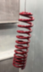 Red coil spring after powdercoating