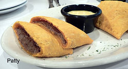 Typical empanada which is a savory pie with meat inside, much like an empanada or a samosa, but the seasonings are distinctly Jamaican.