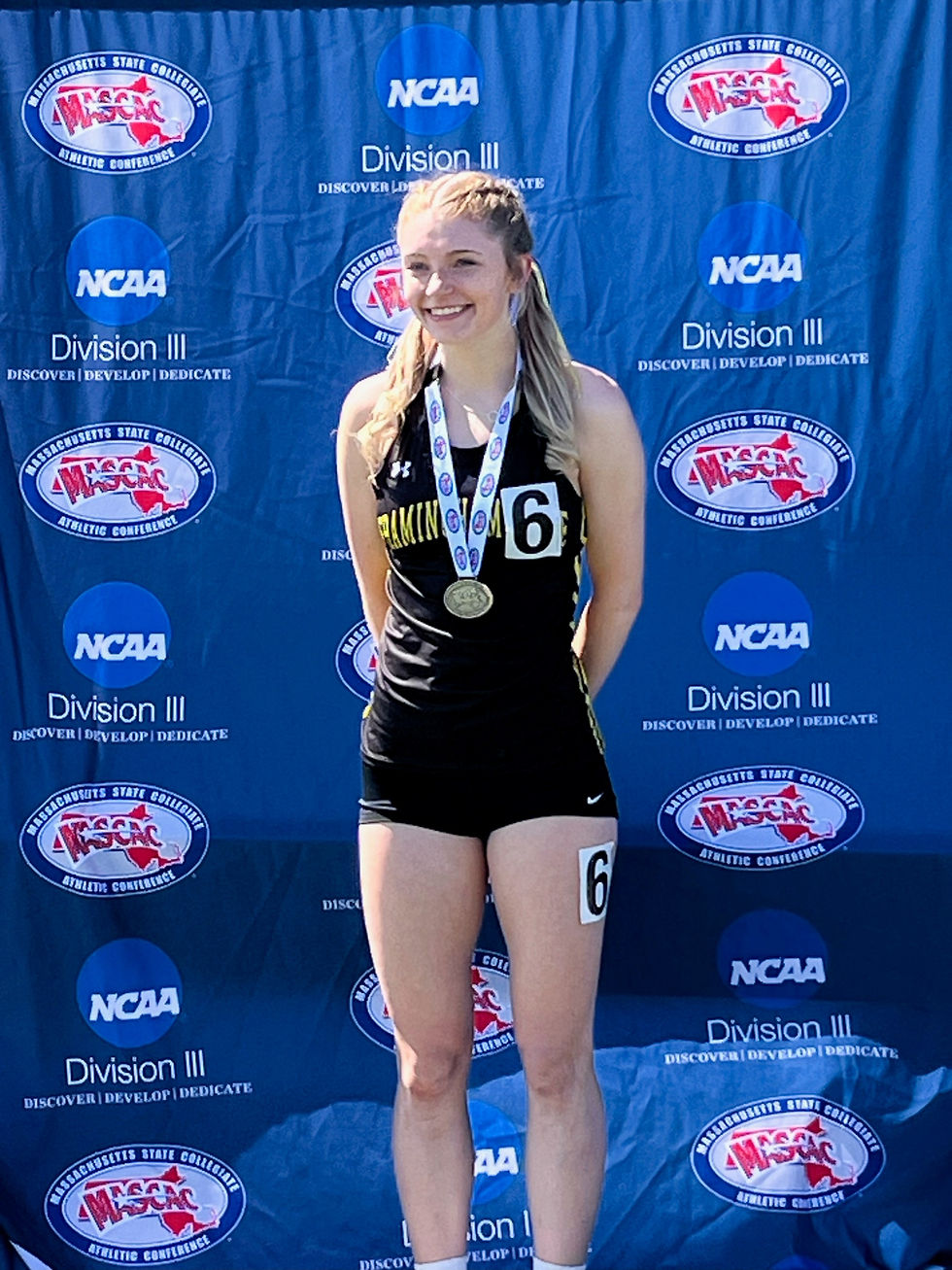 Jamie Moniz standing at the MASCAC Championship meet April 26.