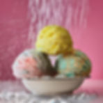 bubble scoops sitting in a bowl in a shower of water