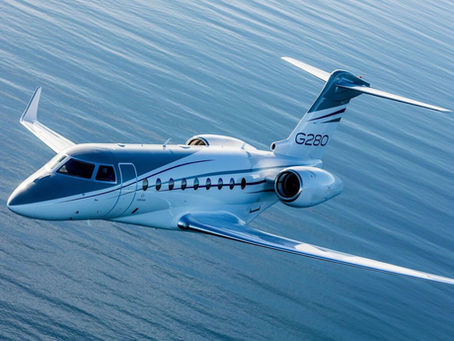 Gulfstream G280 jet flying over the ocean