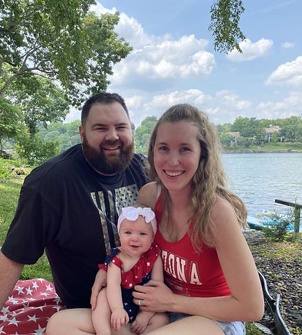 Emily with her husband and baby