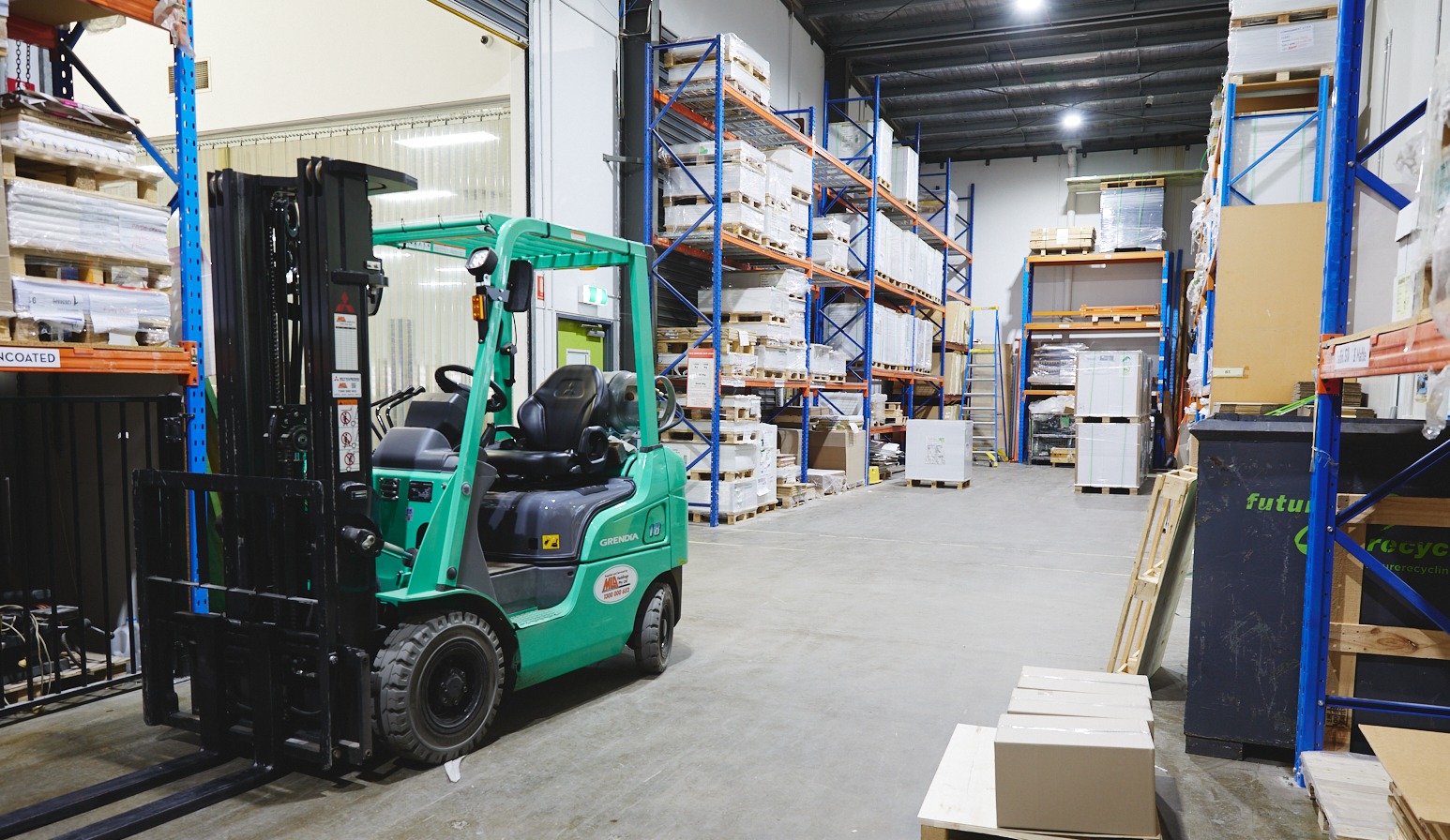 Forklift moving printed stock in Complete Colour's warehouse