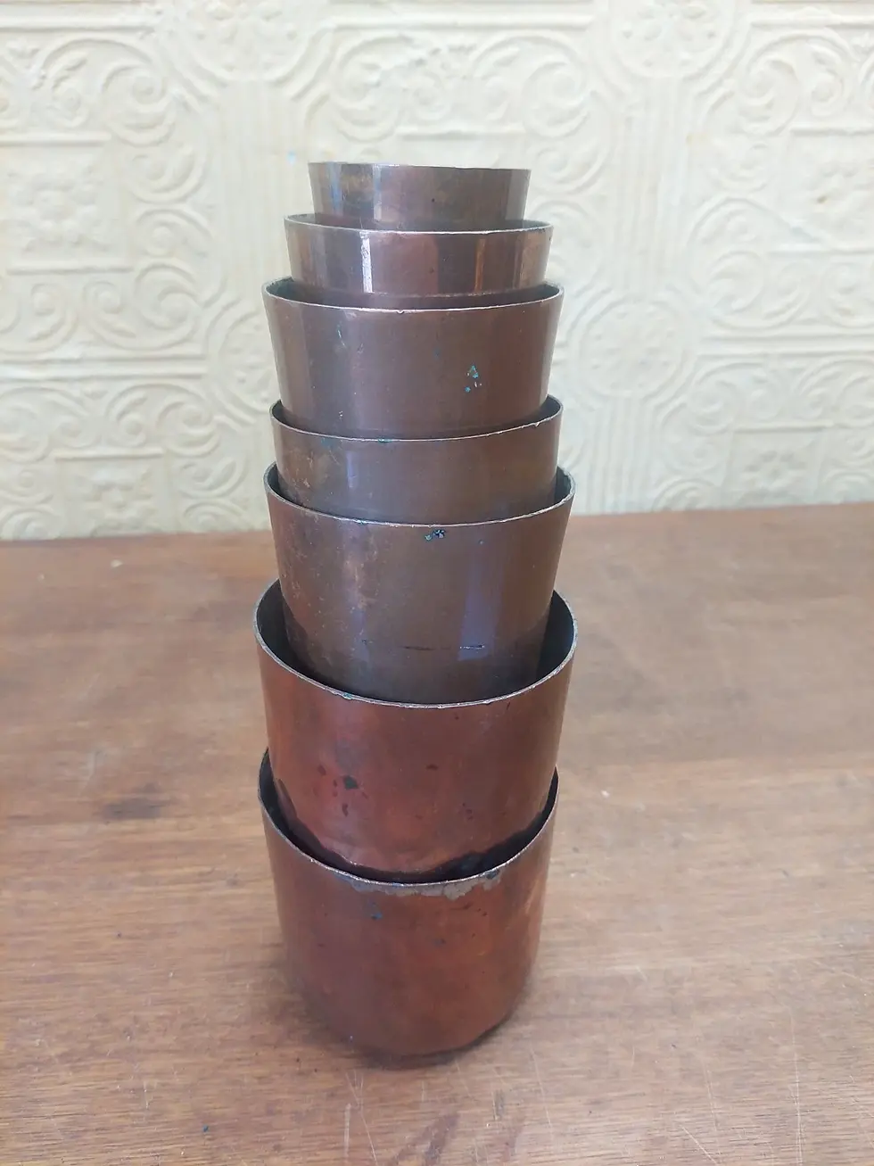 Thumbnail: Set Of 7 Antique French Graduating Copper Rum Baba Moulds Containers