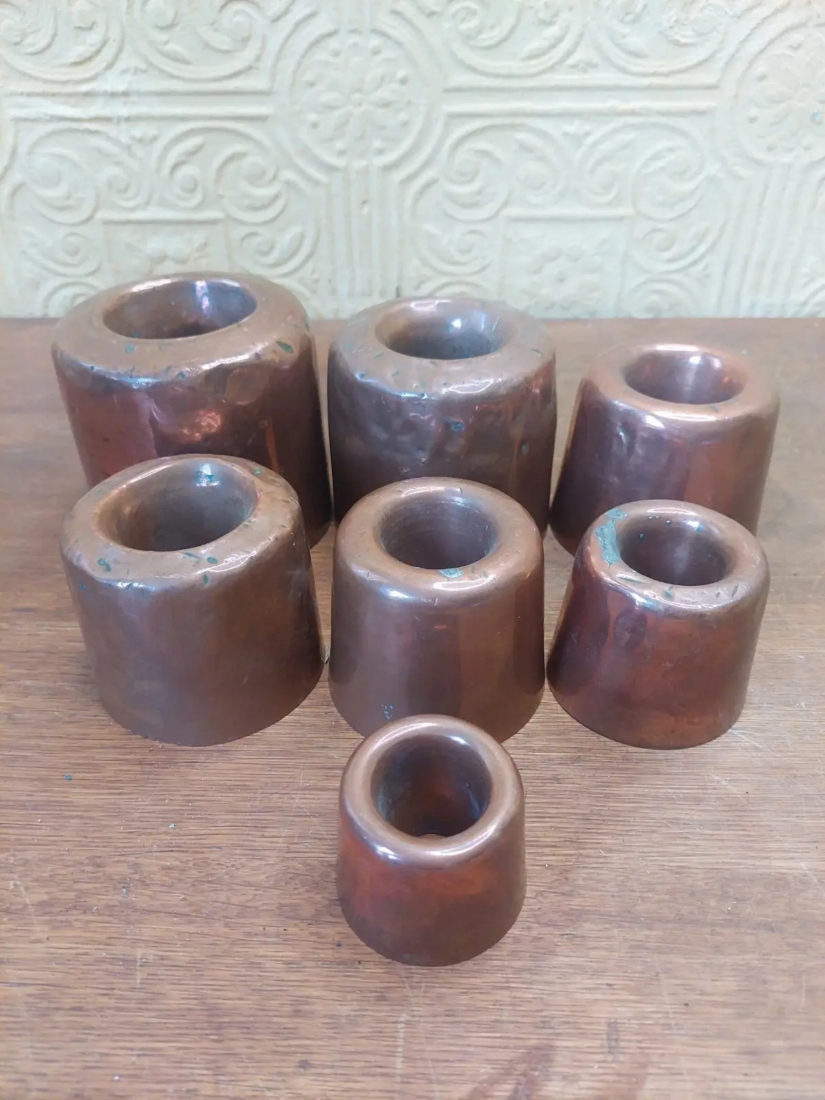 Set Of 7 Antique French Graduating Copper Rum Baba Moulds Containers