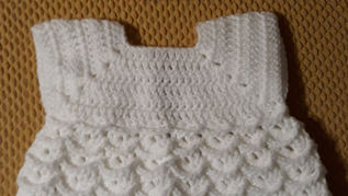 Quality designed knitted baby cap and overgarment. 