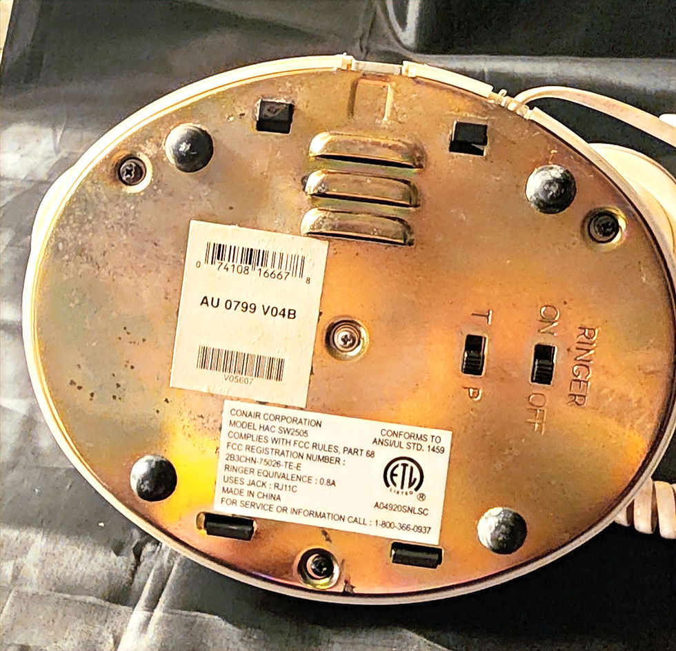 Bottom view of the Vintage French Style Conair Telephone-Model SW2505 featuring the Conair sticker.