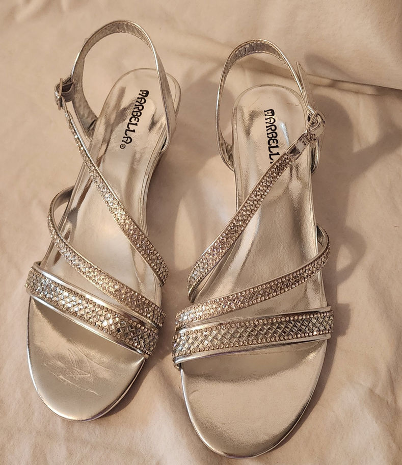 Pair of Marbella women's silver metallic slingback sandals w rhinestone crossover straps.