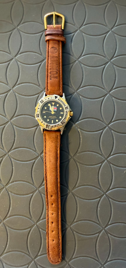 Vintage Lady's Tommy Hilfiger Wristwatch, silver and gold case, gold dial and quarts movement.