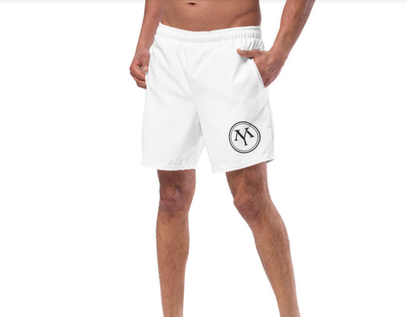 Model wearing white shorts with logo
