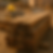 Stack of wooden beams on sandy ground, with a yellow helmet and hammer in the background. Warm lighting suggests a construction site.