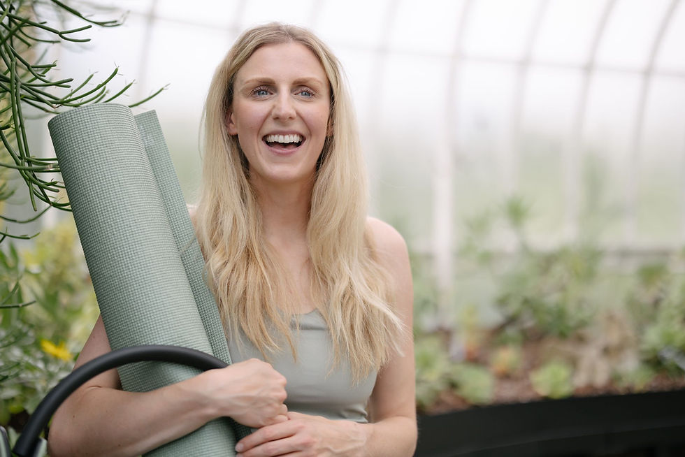 Mandy from move train eat standing smiling with Pilates equipment