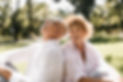 trendy-short-haired-lady-light-hat-striped-blouse-smiling-sitting-grass-with-old-man-glass